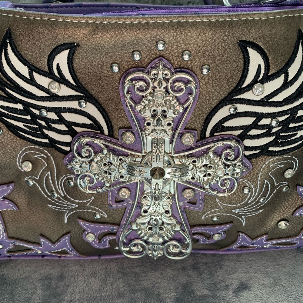 Cross with angel wings purse. Comes with wallet. Never carried.